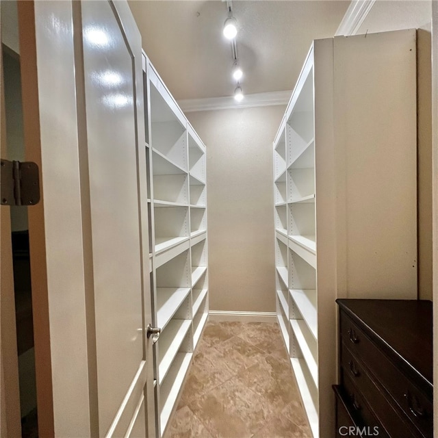 walk in closet featuring light tile floors