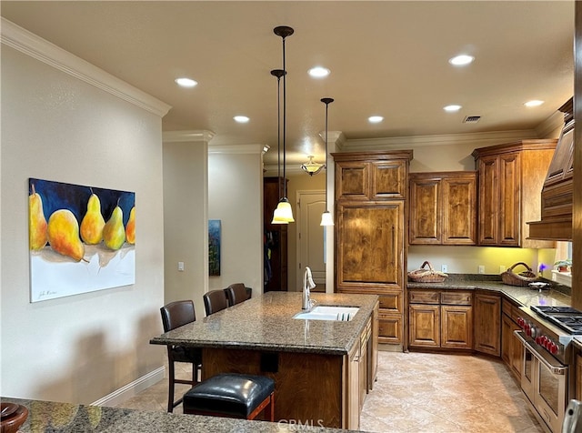 kitchen featuring a kitchen breakfast bar, an island with sink, range with two ovens, light tile floors, and sink