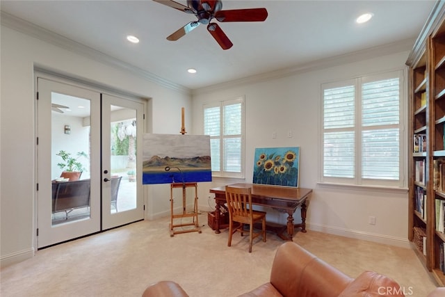 carpeted home office with french doors, ornamental molding, and ceiling fan