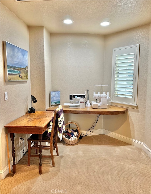 home office with a textured ceiling and carpet flooring