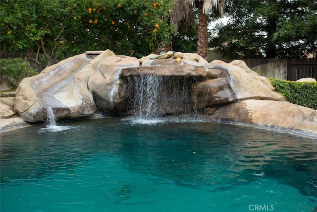 view of swimming pool featuring pool water feature