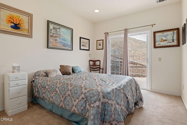 bedroom with light carpet and access to outside