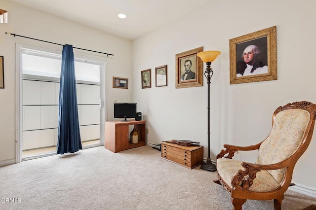 living area featuring light carpet