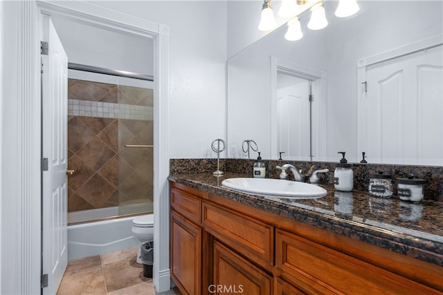 full bathroom with tile flooring, bath / shower combo with glass door, toilet, and large vanity