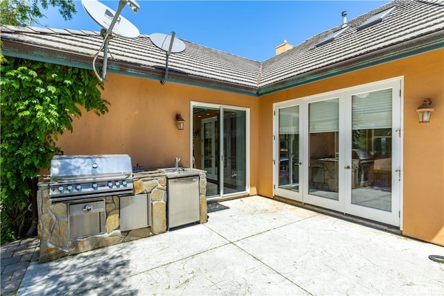 view of patio featuring french doors and exterior kitchen