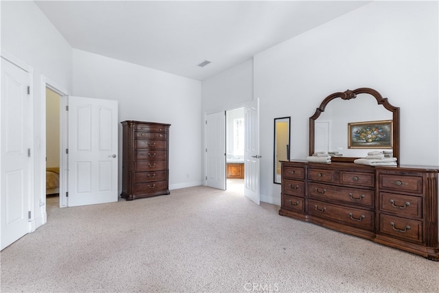 carpeted bedroom with ensuite bath