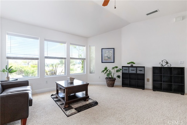 carpeted living room featuring plenty of natural light, ceiling fan, and lofted ceiling