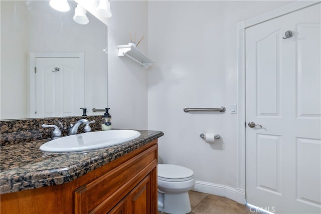 bathroom with vanity, toilet, and tile floors