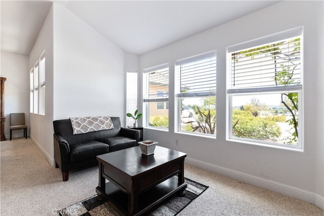 living room with carpet floors, a wealth of natural light, and vaulted ceiling