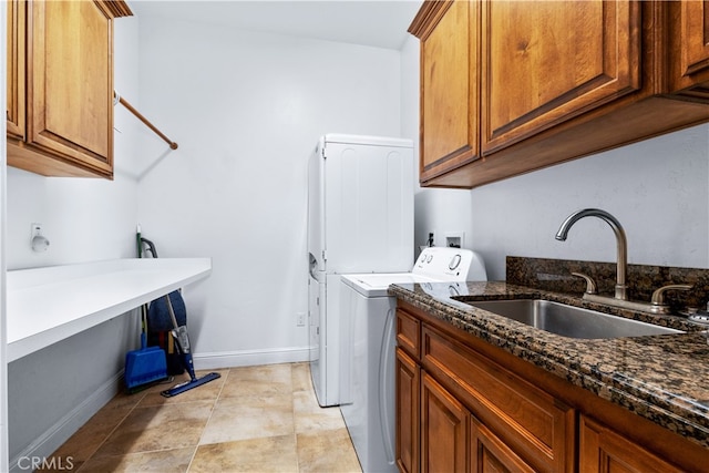 laundry area featuring cabinets, sink, washer / clothes dryer, and light tile floors