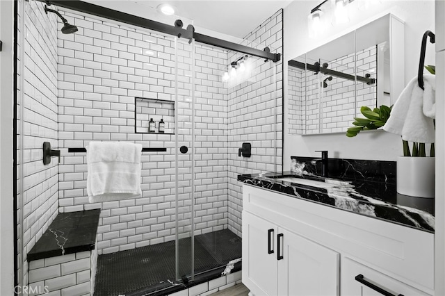 bathroom featuring vanity and an enclosed shower