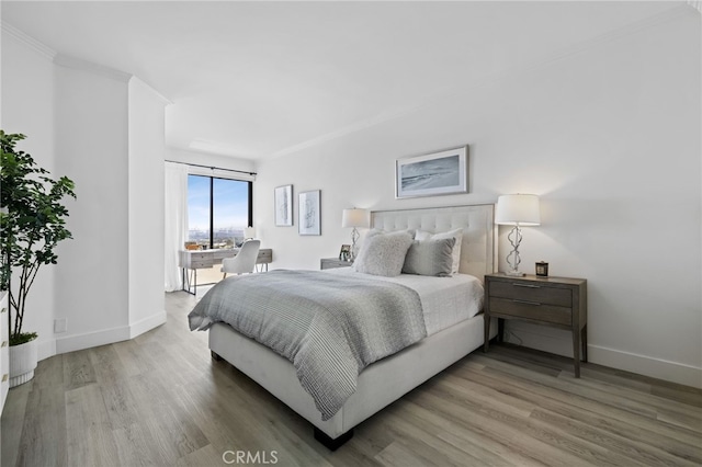 bedroom featuring hardwood / wood-style flooring and ornamental molding