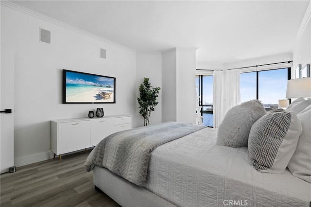 bedroom featuring ornamental molding, dark wood-type flooring, and access to outside