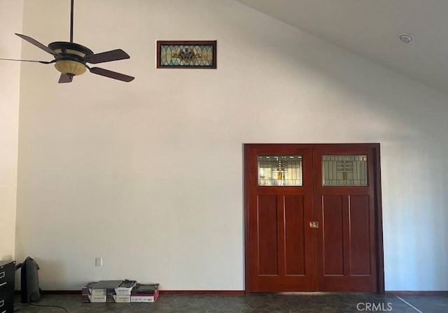 foyer entrance with ceiling fan and lofted ceiling