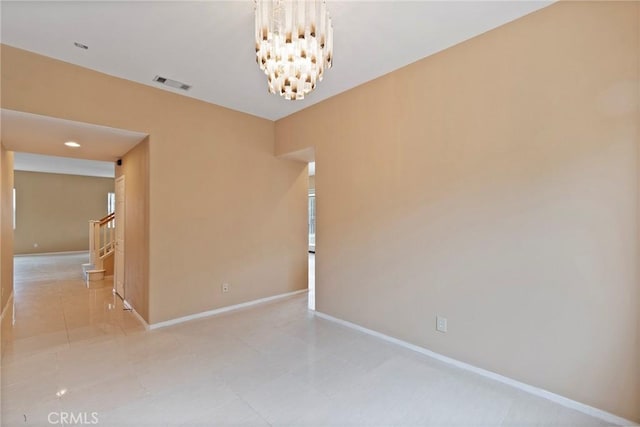 empty room featuring a chandelier