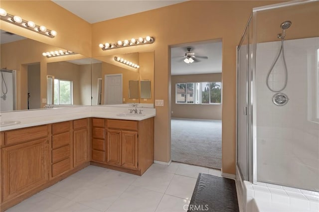 bathroom featuring tile patterned flooring, a shower with shower door, and a healthy amount of sunlight