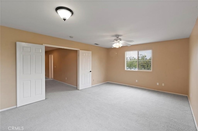 empty room featuring light carpet and ceiling fan