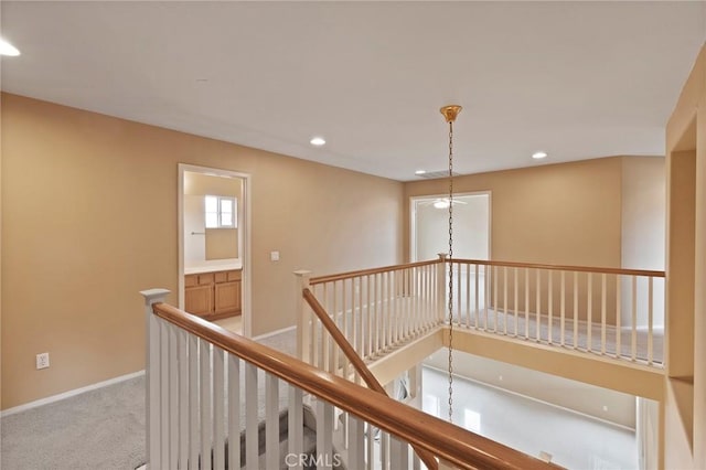 hallway with light colored carpet