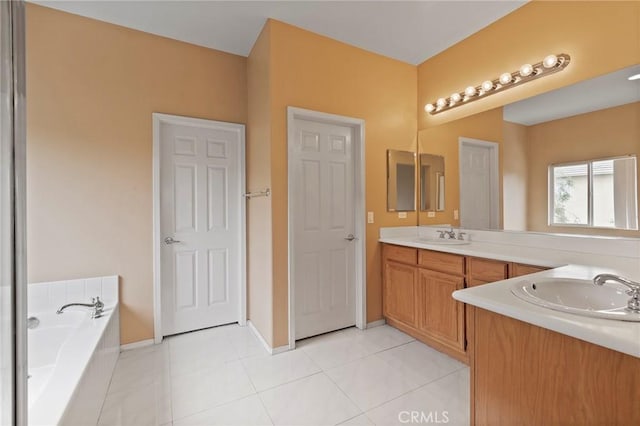 bathroom featuring vanity, tile patterned floors, and a tub