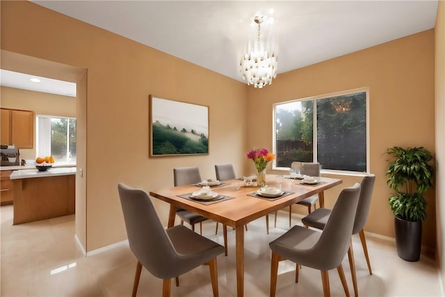 tiled dining room featuring a notable chandelier