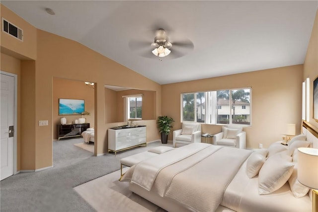 bedroom featuring multiple windows, ceiling fan, light colored carpet, and lofted ceiling