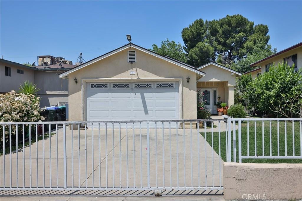 single story home featuring a front yard and a garage