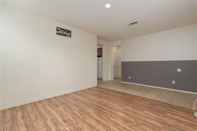 empty room with light hardwood / wood-style floors