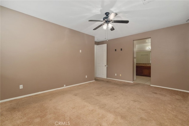 carpeted spare room with ceiling fan