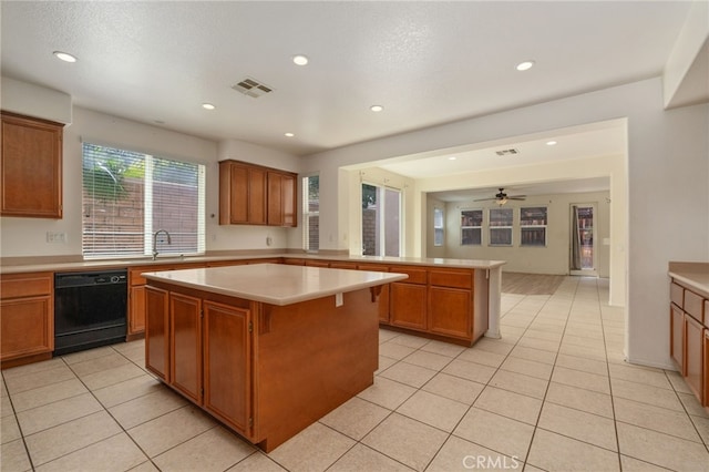 kitchen featuring a center island, sink, light tile flooring, ceiling fan, and black dishwasher