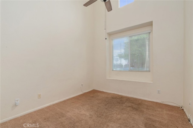 empty room with carpet flooring, plenty of natural light, and ceiling fan