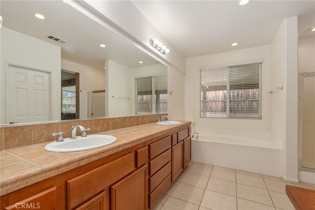 bathroom featuring tile flooring, shower with separate bathtub, and double vanity