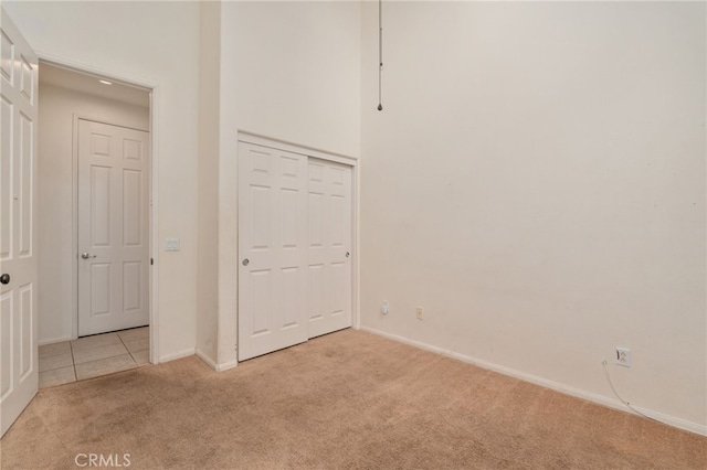 unfurnished bedroom featuring a closet and light tile flooring