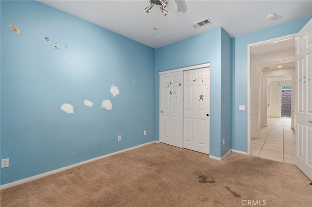 unfurnished bedroom featuring a closet, ceiling fan, and light tile floors