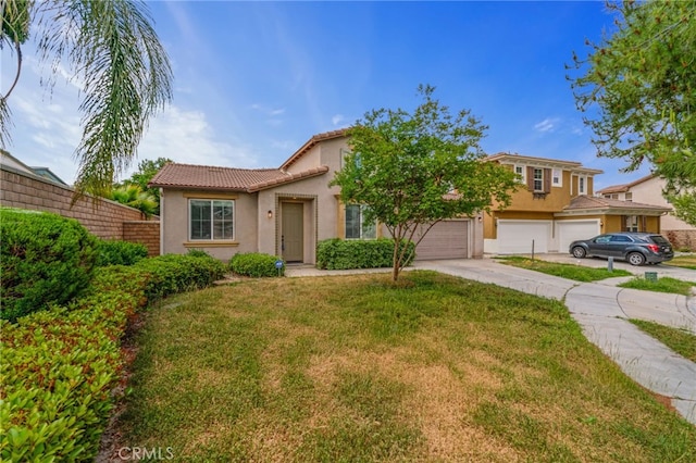 mediterranean / spanish-style home with a front yard and a garage