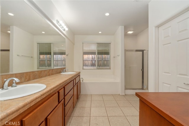 bathroom featuring dual sinks, tile flooring, shower with separate bathtub, and large vanity