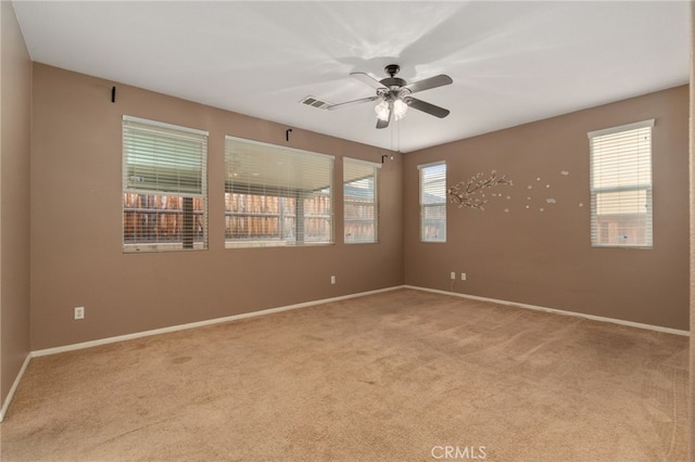 unfurnished room with ceiling fan and carpet flooring