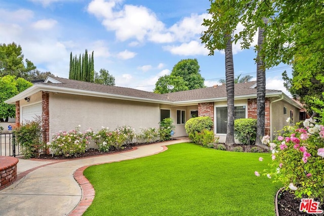 ranch-style house with a garage and a front lawn