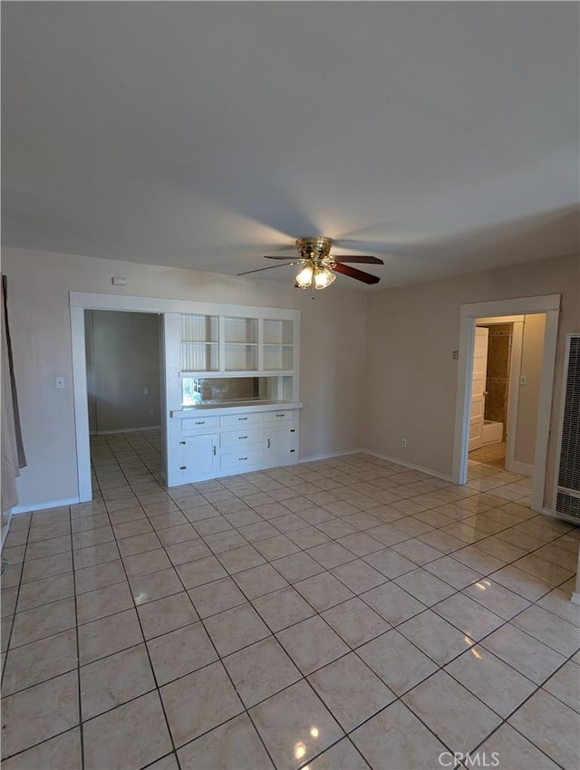 unfurnished living room featuring light tile patterned floors and ceiling fan