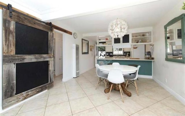 tiled dining space with a chandelier and a barn door