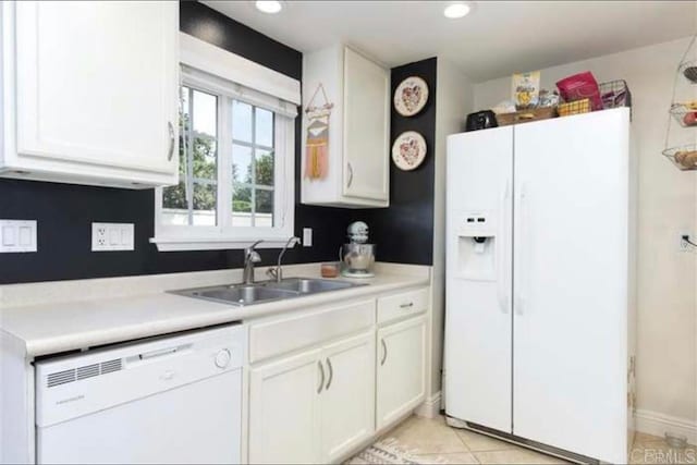 kitchen with sink, white cabinets, white appliances, and light tile patterned floors