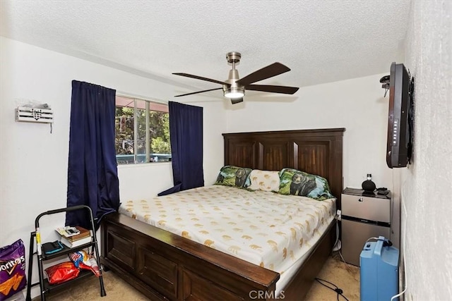 bedroom with light carpet, a textured ceiling, and ceiling fan