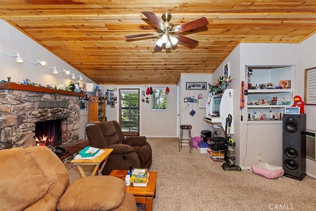 carpeted living room featuring ceiling fan, a stone fireplace, wood ceiling, and lofted ceiling