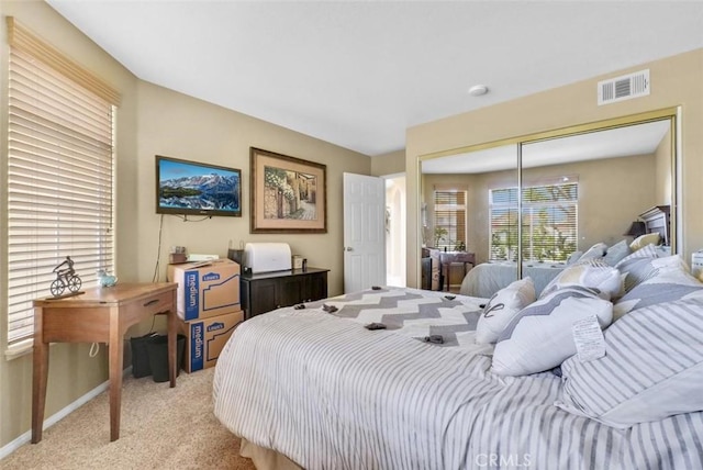 carpeted bedroom with a closet