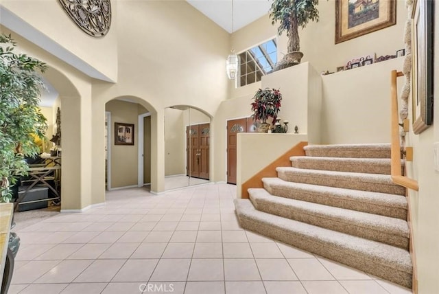 tiled entrance foyer with a high ceiling