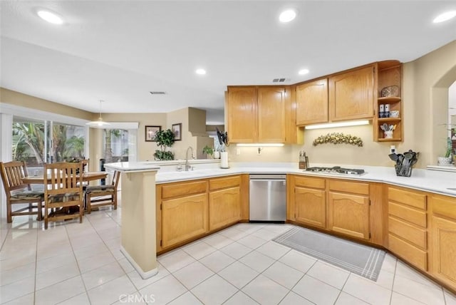 kitchen featuring light tile patterned floors, kitchen peninsula, appliances with stainless steel finishes, and sink