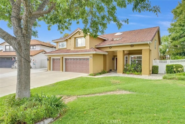 mediterranean / spanish house with a garage and a front lawn