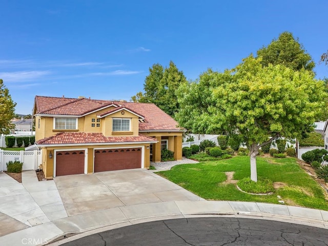 mediterranean / spanish-style house with a front lawn and a garage