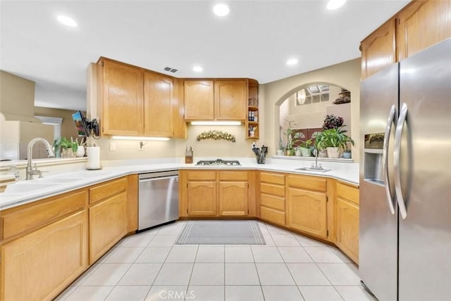 kitchen featuring light tile patterned floors, appliances with stainless steel finishes, and sink