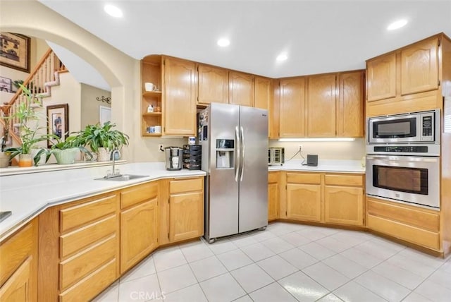 kitchen featuring light tile patterned floors, appliances with stainless steel finishes, and sink