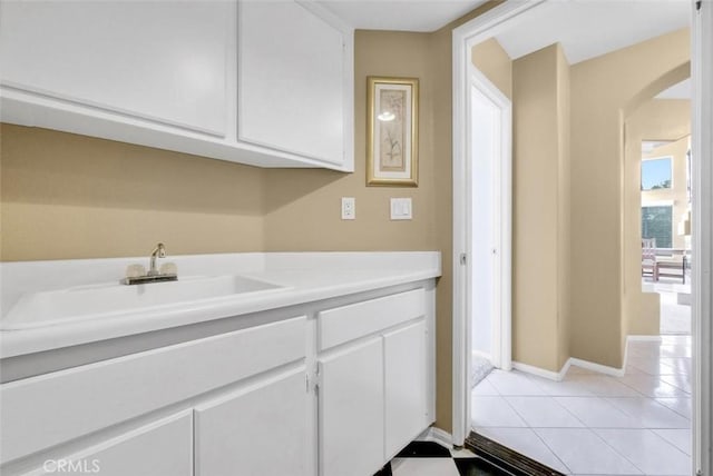 interior space featuring light tile patterned floors and sink